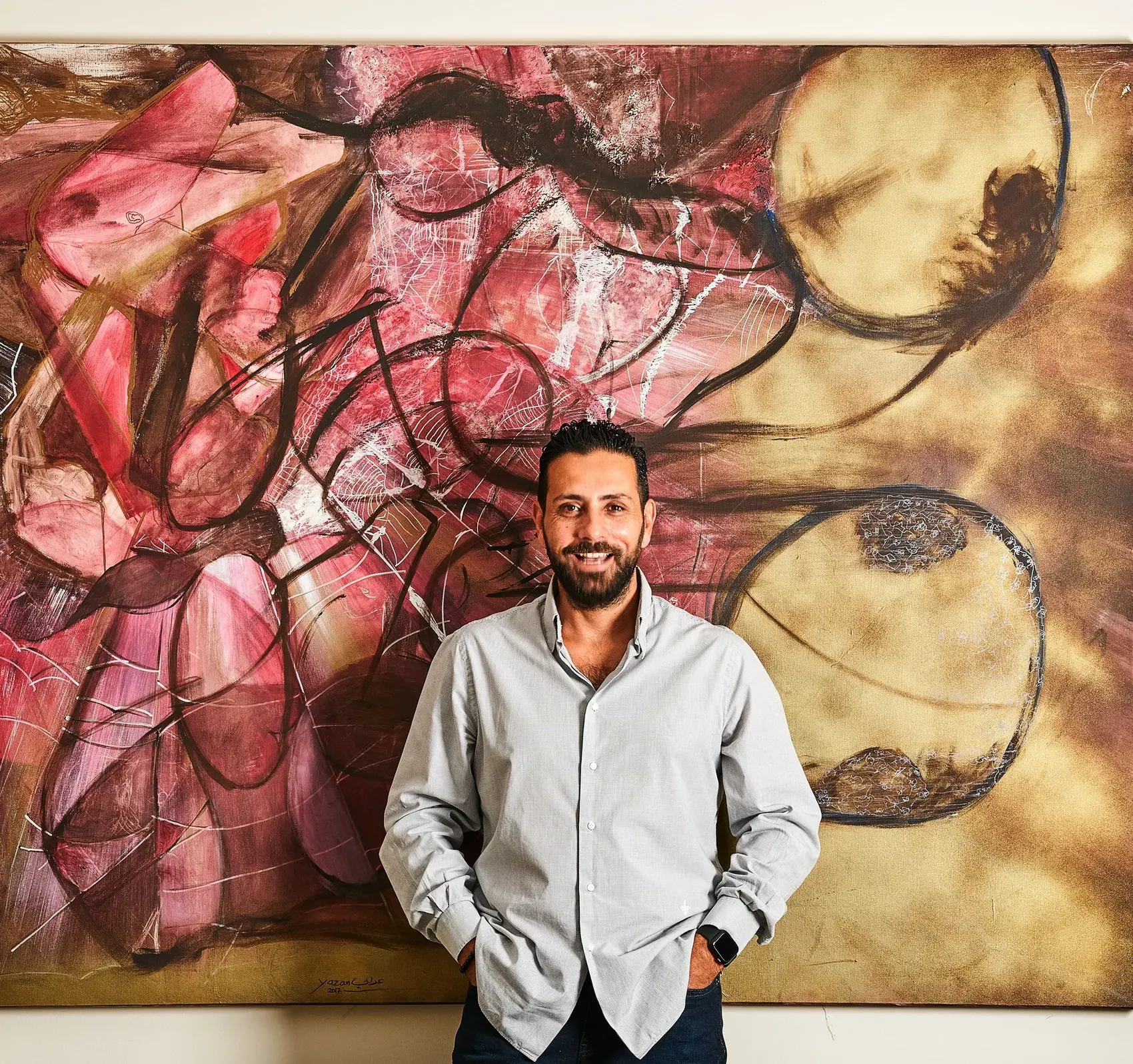 Yazan Orabi with a pink and gold canvas