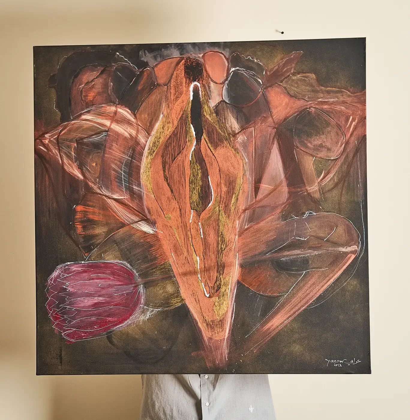 Yazan Orabi holding a canvas in front of himself